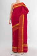 Maroon Kanchipuram Silk Saree with Plain Body and Zari Border.  displayed on a mannequin