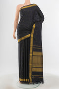 Pure Silk Pure Zari Black Kanchipuram Saree with Zari Butta on the body and Silk Border.  displayed on a mannequin
