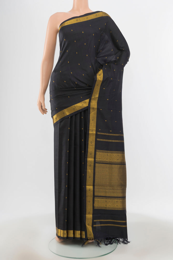 Pure Silk Pure Zari Black Kanchipuram Saree with Zari Butta on the body and Silk Border.  displayed on a mannequin