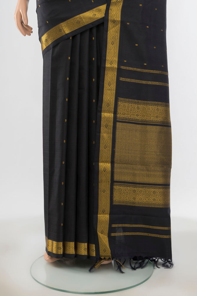 Pleats and pallu of Pure Silk Pure Zari Black Kanchipuram Saree with Zari Butta on the body and Silk Border. 
