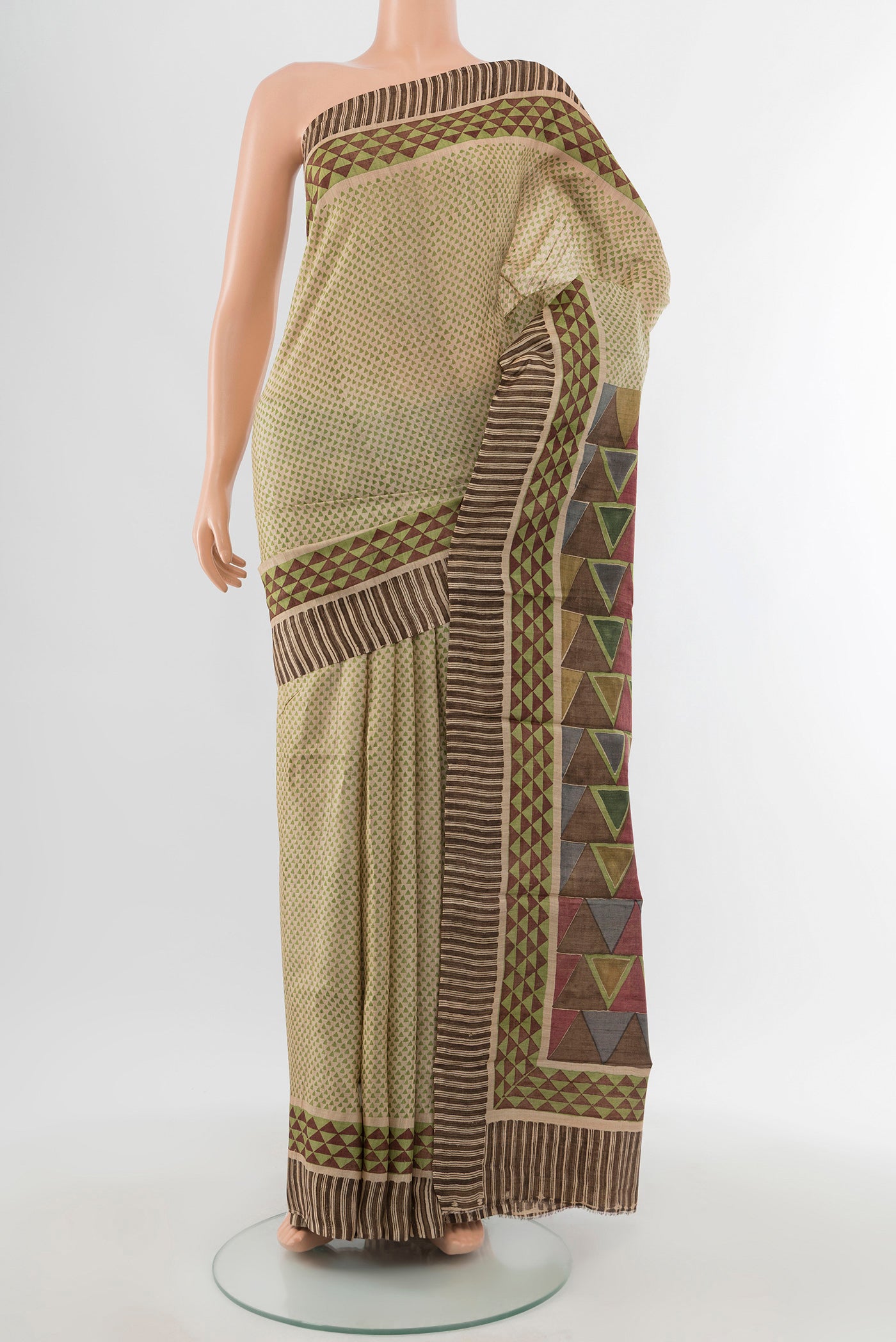 Beige Tussar Silk Saree with Floral Print on the body and Printed Border.  displayed on a mannequin
