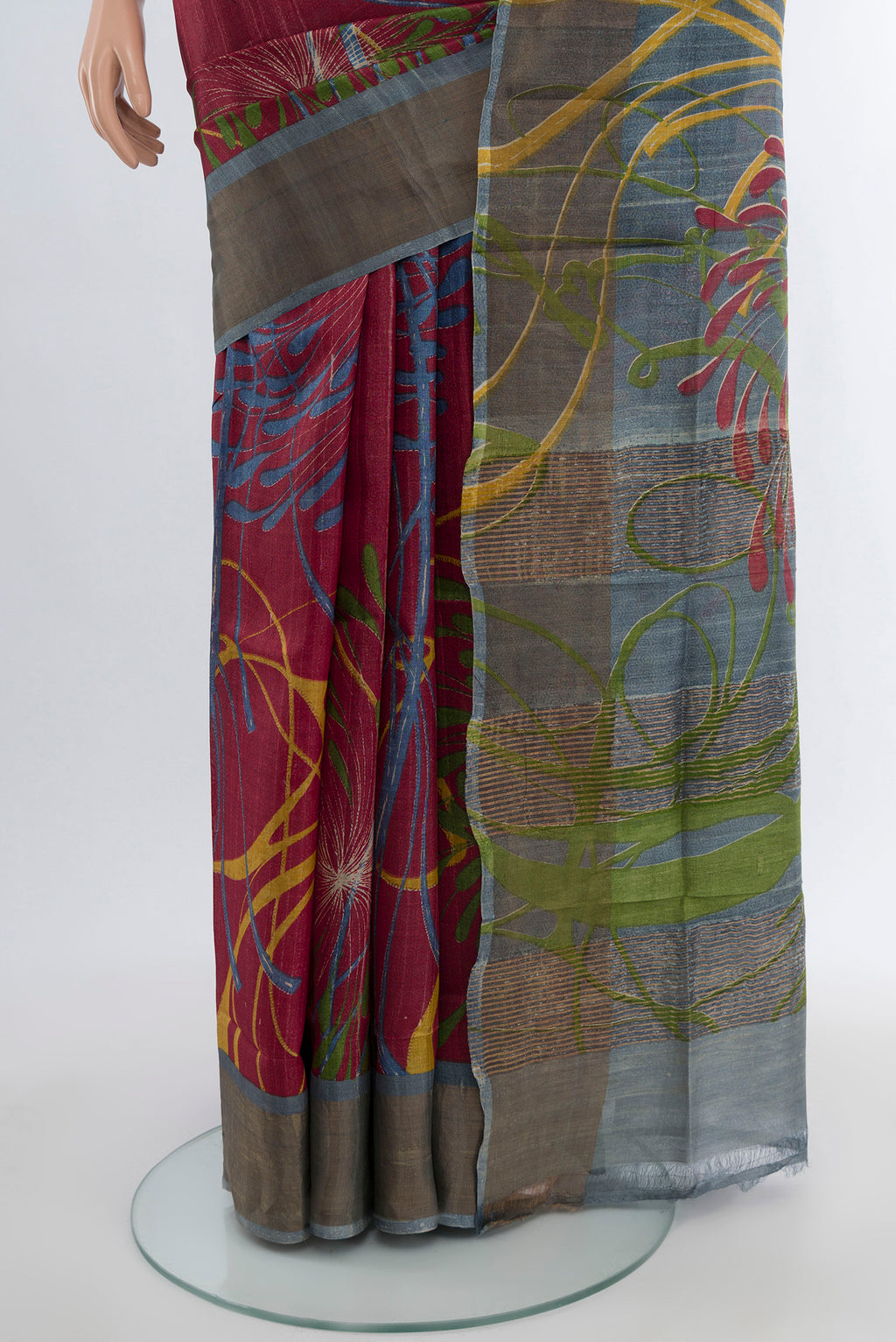 Pleats and pallu of Maroon Tussar Silk Saree with Floral Print on the body and Zari Border. 