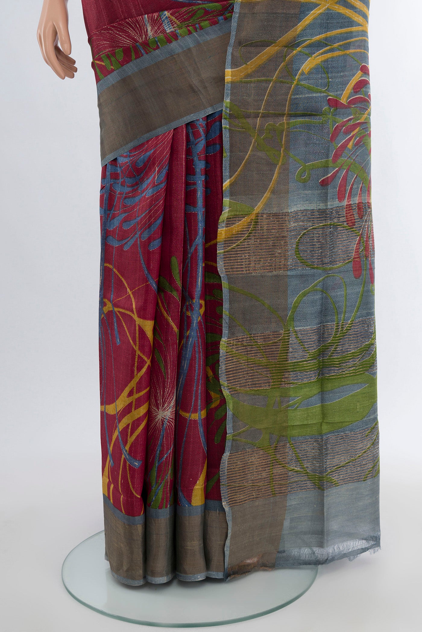 Pleats and pallu of Maroon Tussar Silk Saree with Floral Print on the body and Zari Border. 