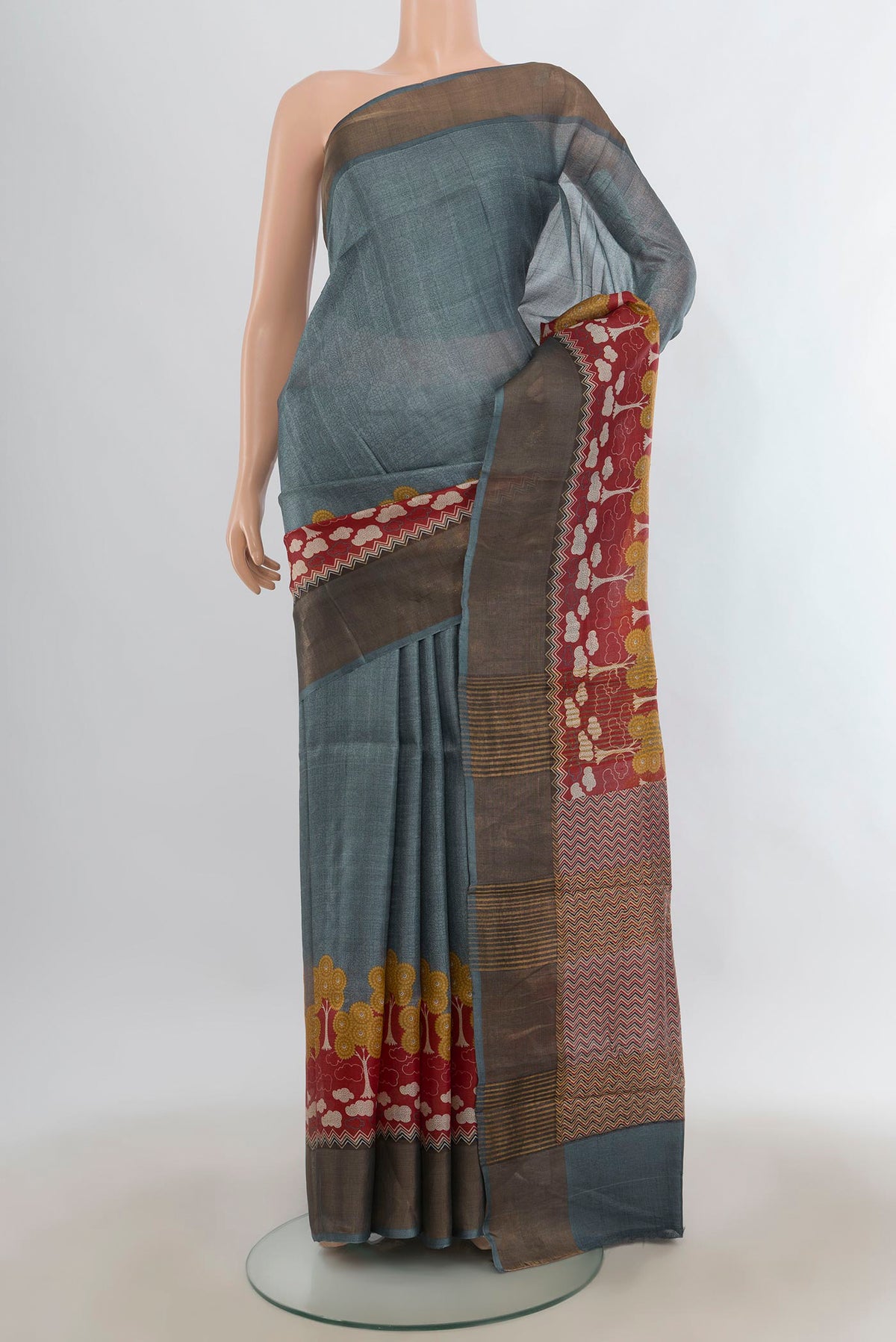Grey Tussar Saree with Plain Body and Zari Border.  displayed on a mannequin