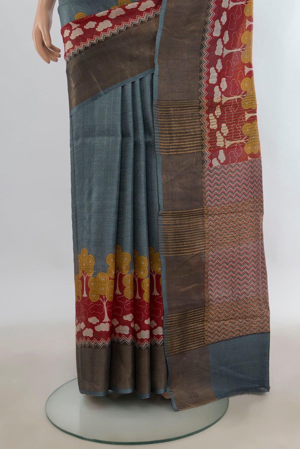 Pleats and pallu of Grey Tussar Saree with Plain Body and Zari Border. 