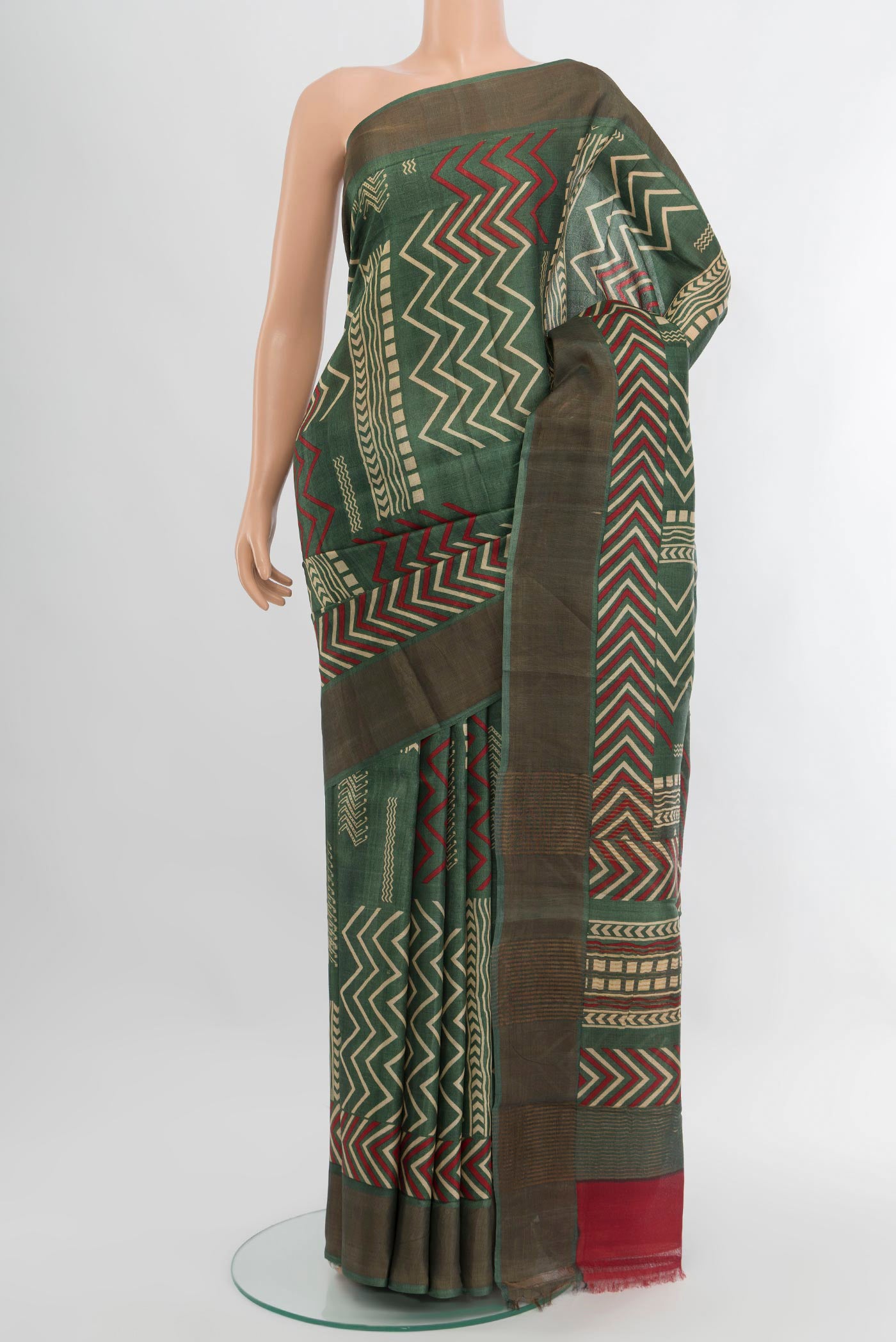 Green Tussar Silk Saree with Floral Print on the body and Zari Border.  displayed on a mannequin