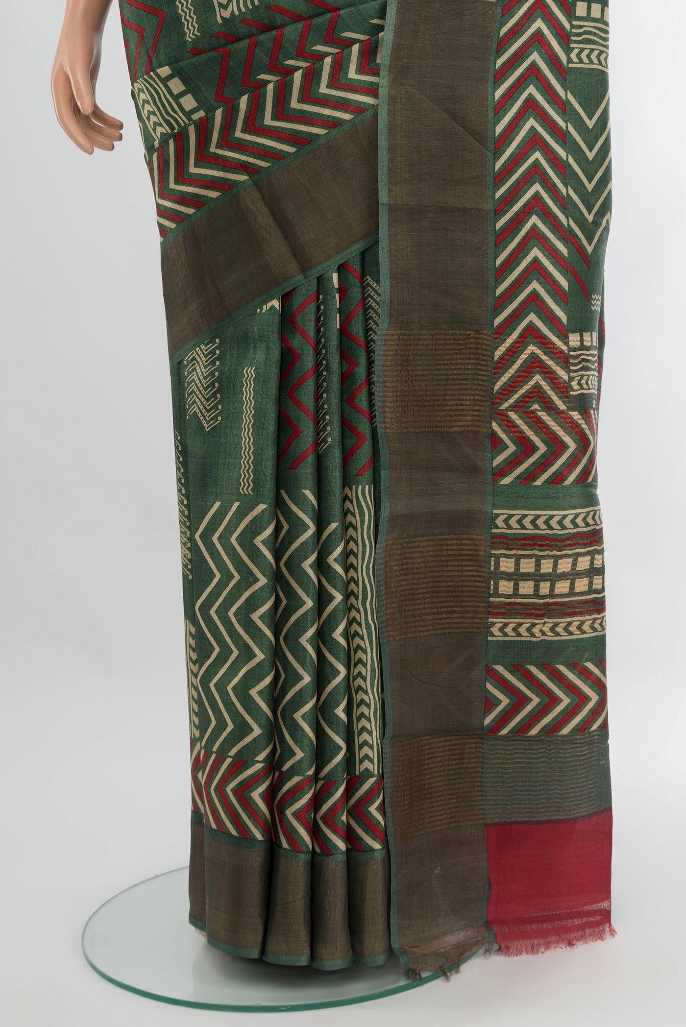 Pleats and pallu of Green Tussar Silk Saree with Floral Print on the body and Zari Border. 