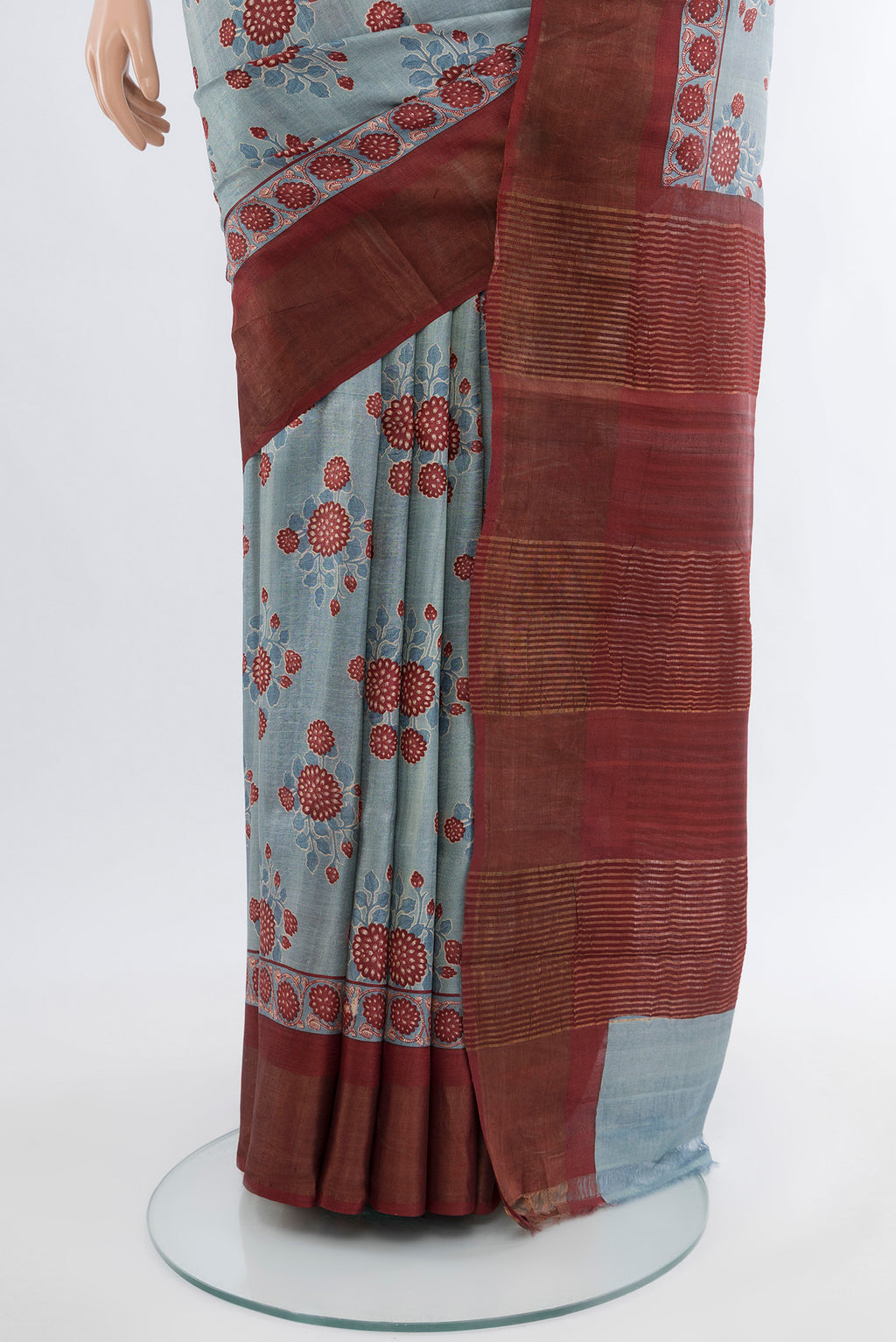 Pleats and pallu of Grey Tussar Silk Saree with Floral Print on the body and Zari Border. 