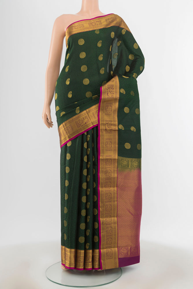 Mint Green Kanchipuram Silk Saree with Zari Butta on the body and Silk Border.  displayed on a mannequin