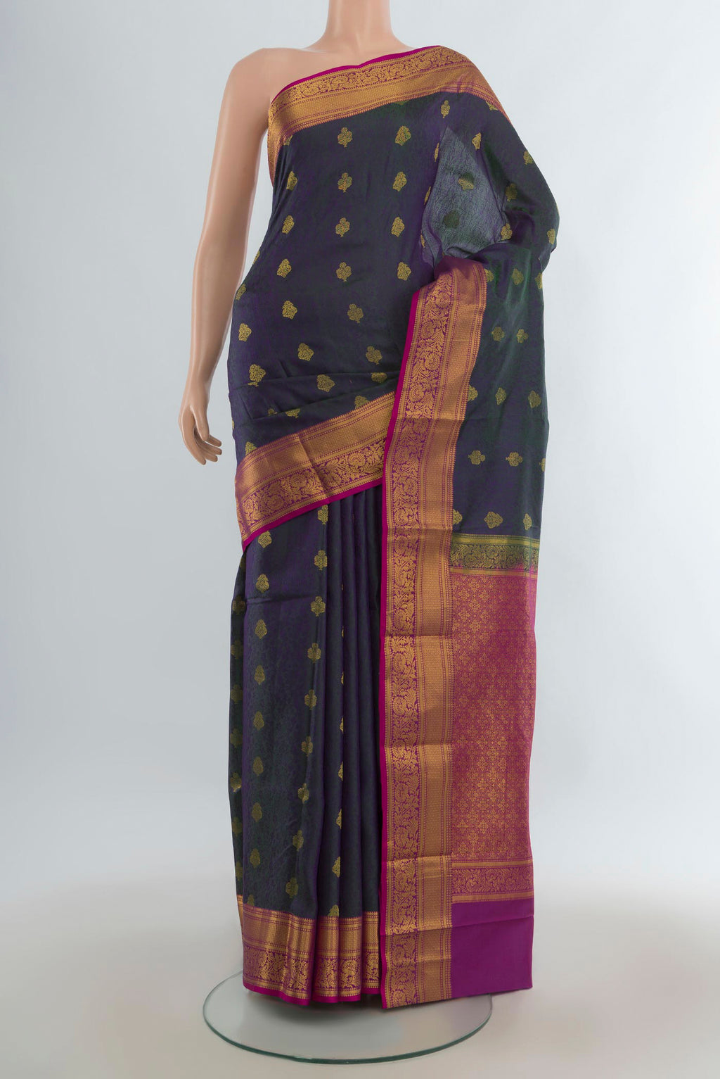 Pure Silk Green Dual Tone Kanchipuram Saree with Zari Butta on the body and Zari Border.  displayed on a mannequin