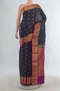 Pure Silk Green Dual Tone Kanchipuram Saree with Zari Butta on the body and Zari Border.  displayed on a mannequin