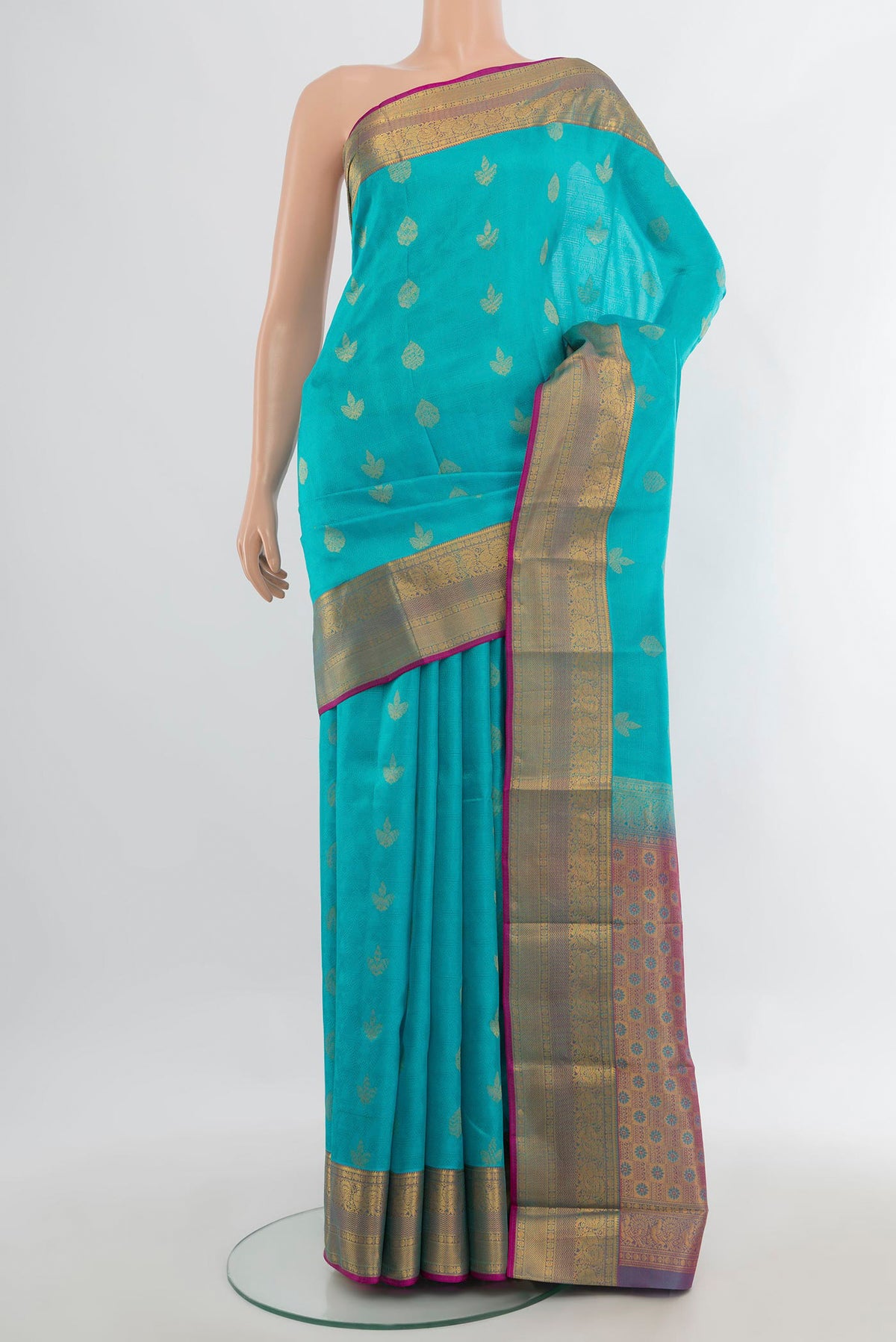 Pure Silk Light Blue Kanchipuram Saree with Zari Butta on the body and Zari Border.  displayed on a mannequin
