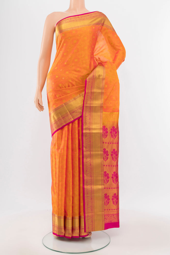 Orange Kanchipuram Silk Saree with Zari Butta on the body and Silk Border.  displayed on a mannequin