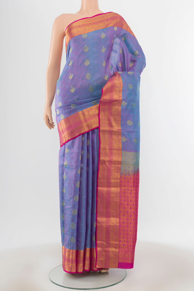 Light Blue Kanchipuram Silk Saree with Zari Butta on the body and Silk Border.  displayed on a mannequin