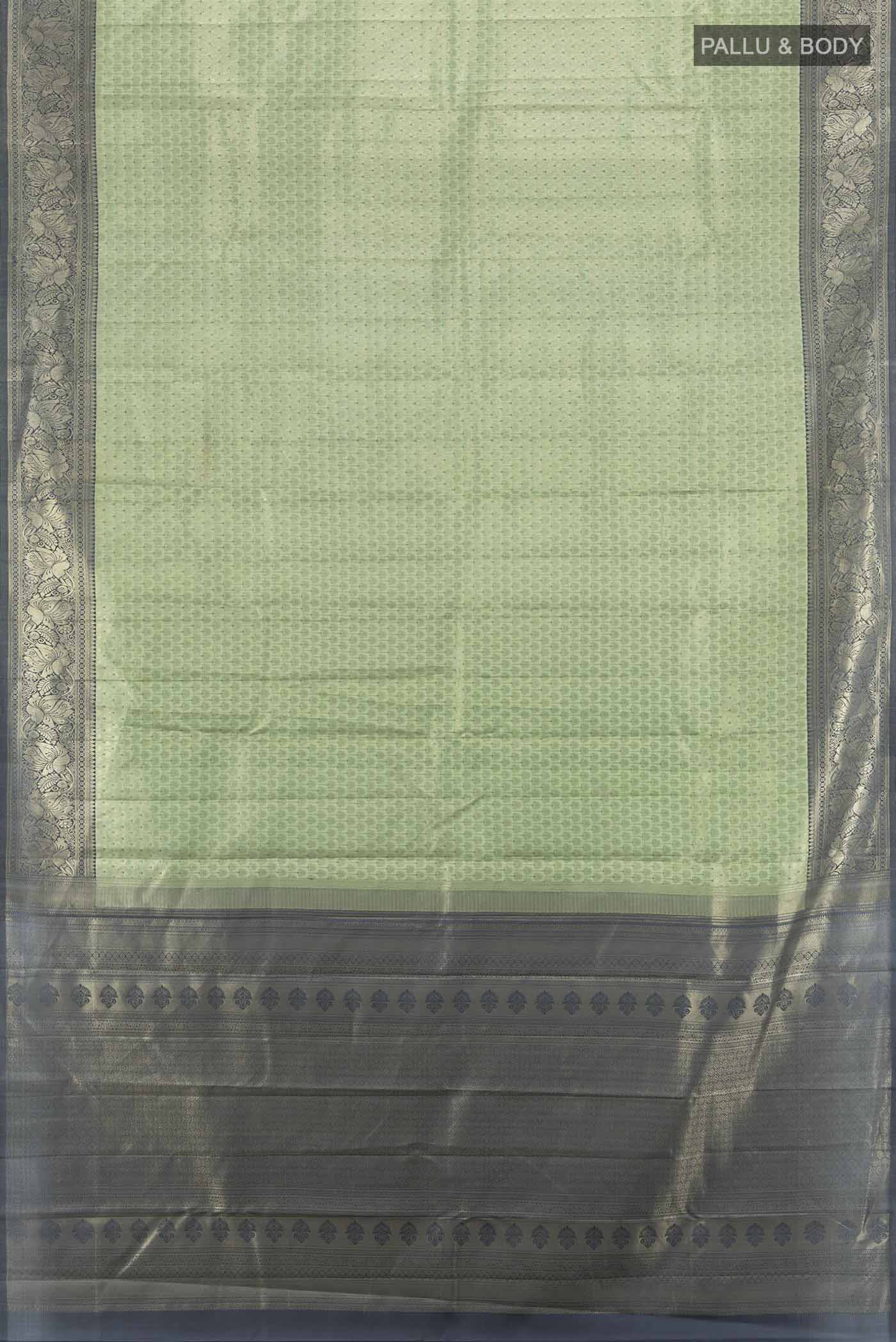 Flat view of Light Green Kanchipuram Silk Saree with Zari Butta on the body and Silk Border. 