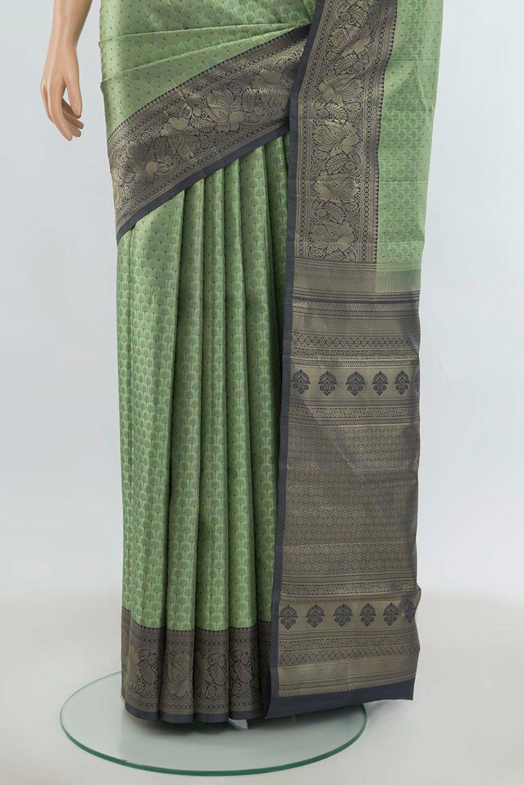 Pleats and pallu of Light Green Kanchipuram Silk Saree with Zari Butta on the body and Silk Border. 