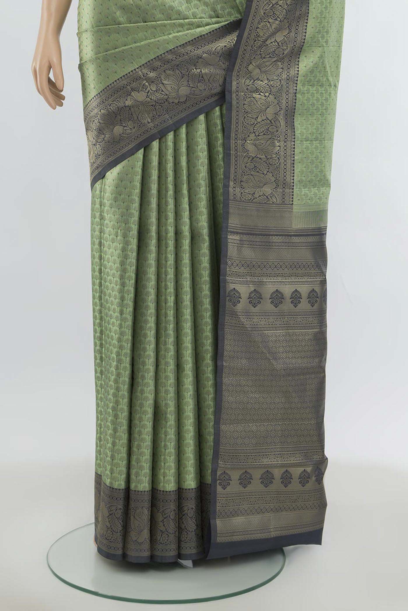 Pleats and pallu of Light Green Kanchipuram Silk Saree with Zari Butta on the body and Silk Border. 