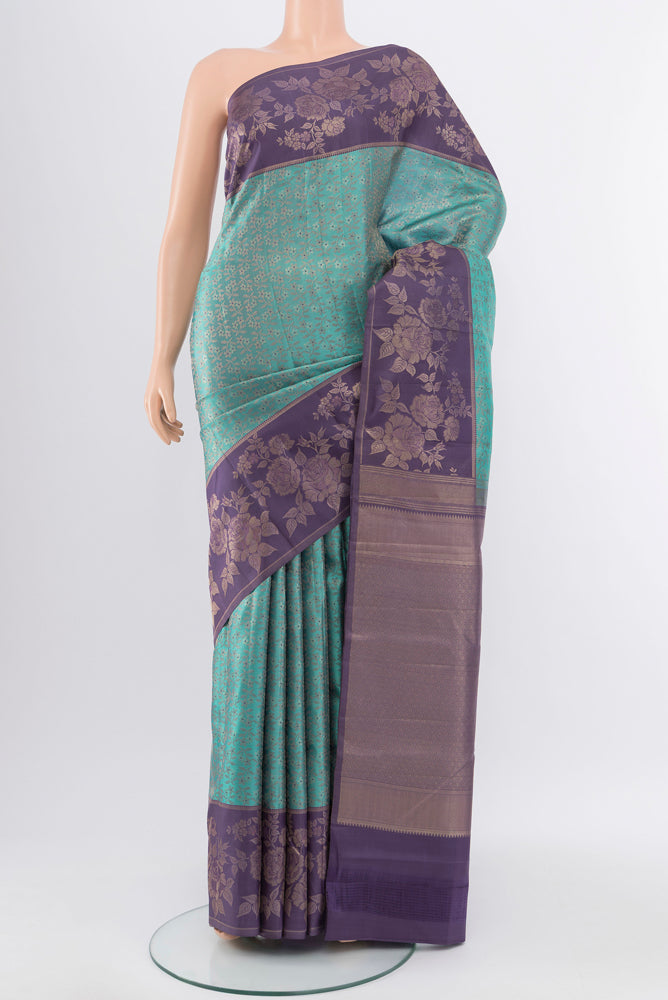 Pure Silk Pure Zari Olive Green Kanchipuram Saree with Zari Butta on the body and Silk Border.  displayed on a mannequin