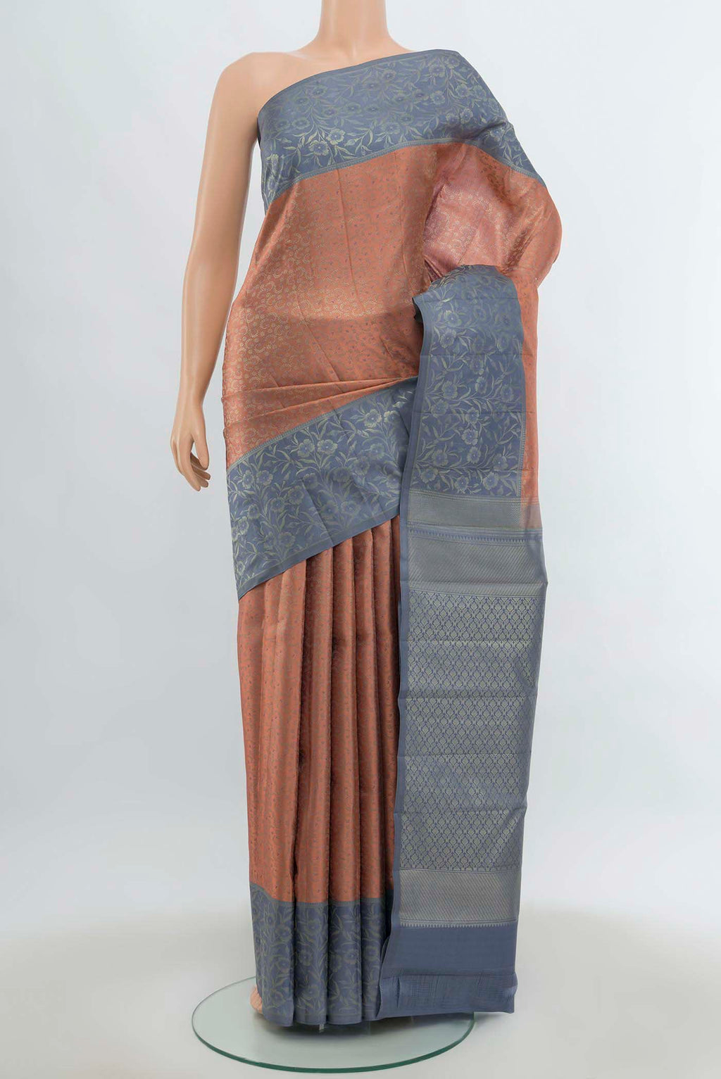 Peach Kanchipuram Silk Saree with Zari Butta on the body and Silk Border.  displayed on a mannequin