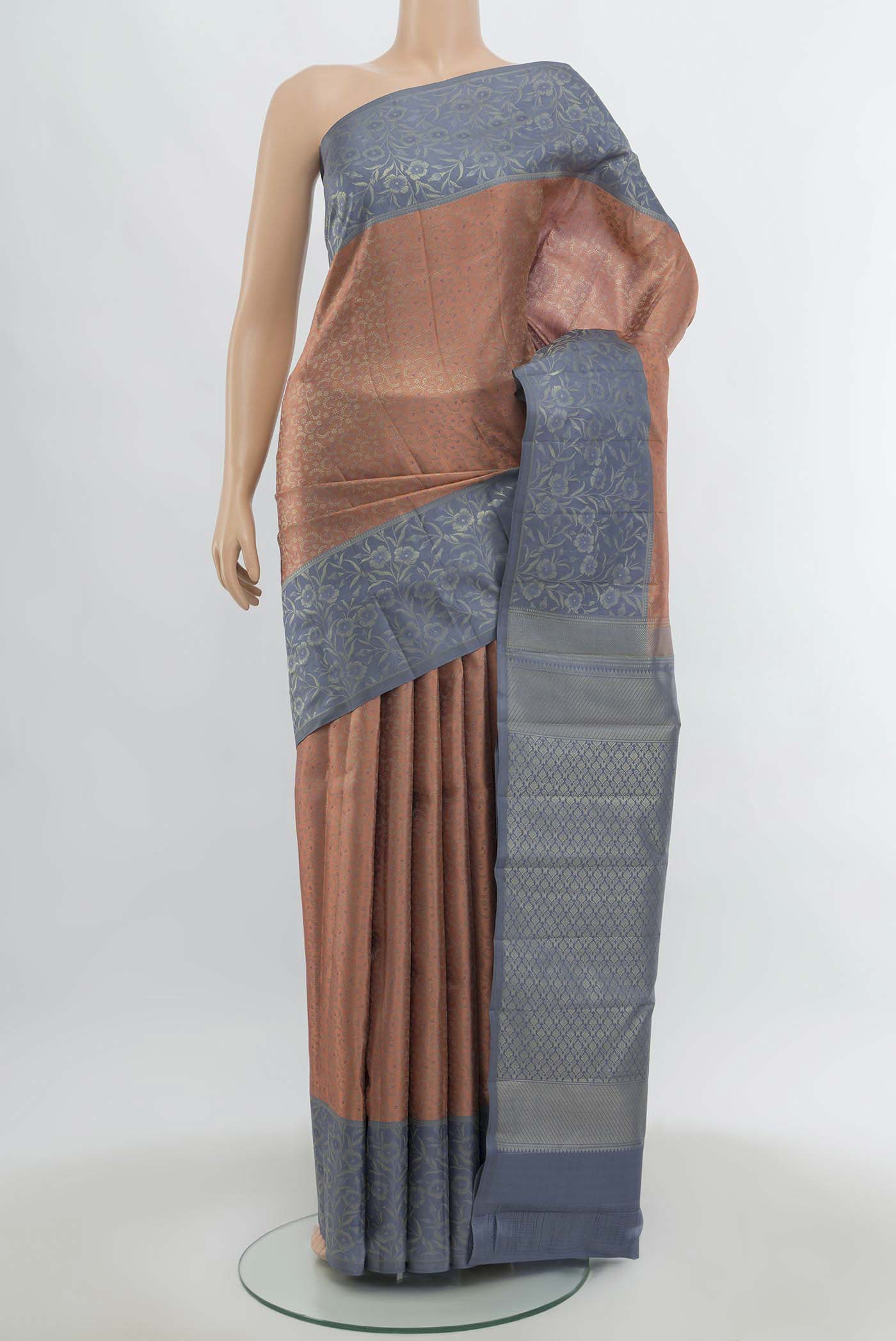 Peach Kanchipuram Silk Saree with Zari Butta on the body and Silk Border.  displayed on a mannequin