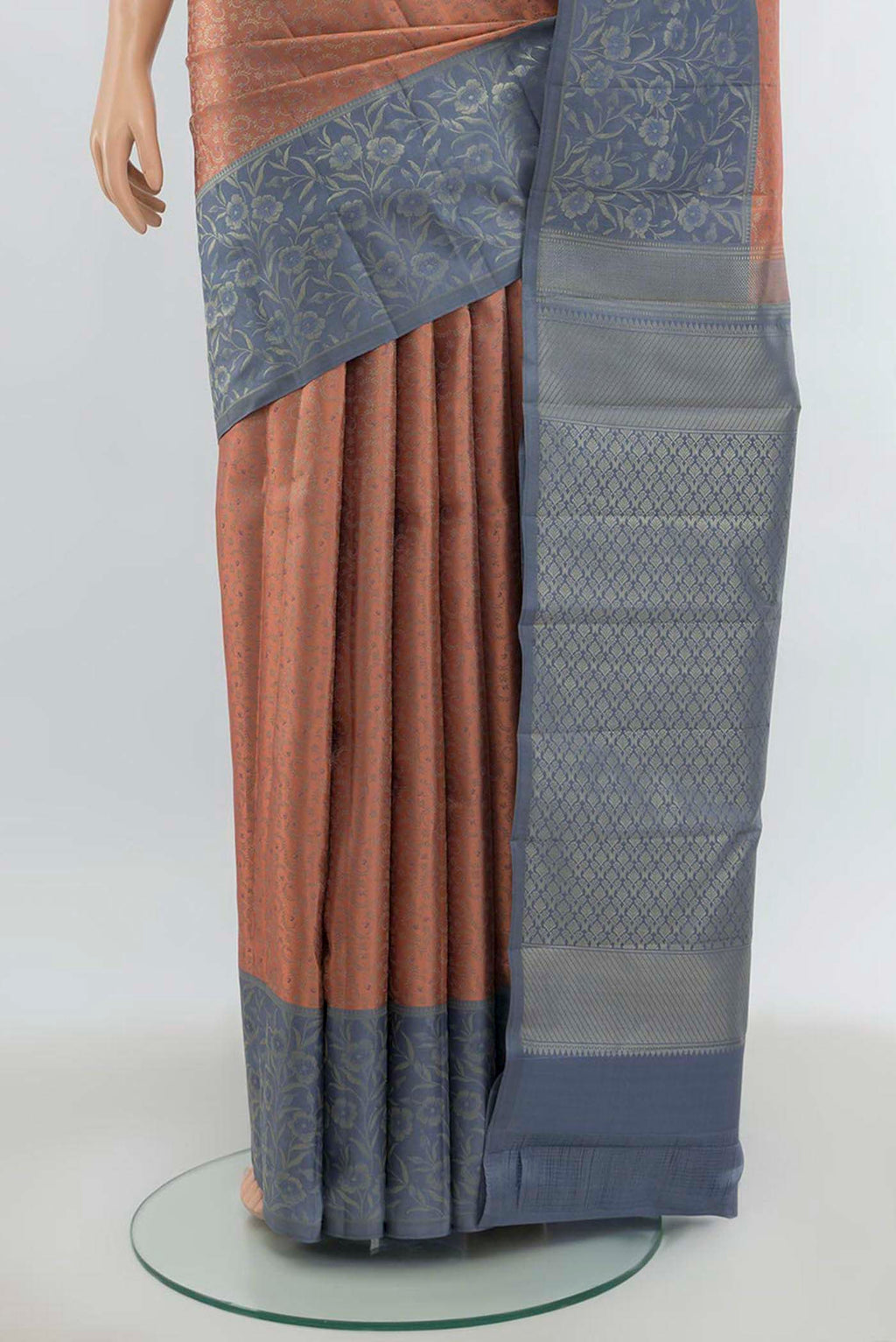 Pleats and pallu of Peach Kanchipuram Silk Saree with Zari Butta on the body and Silk Border. 