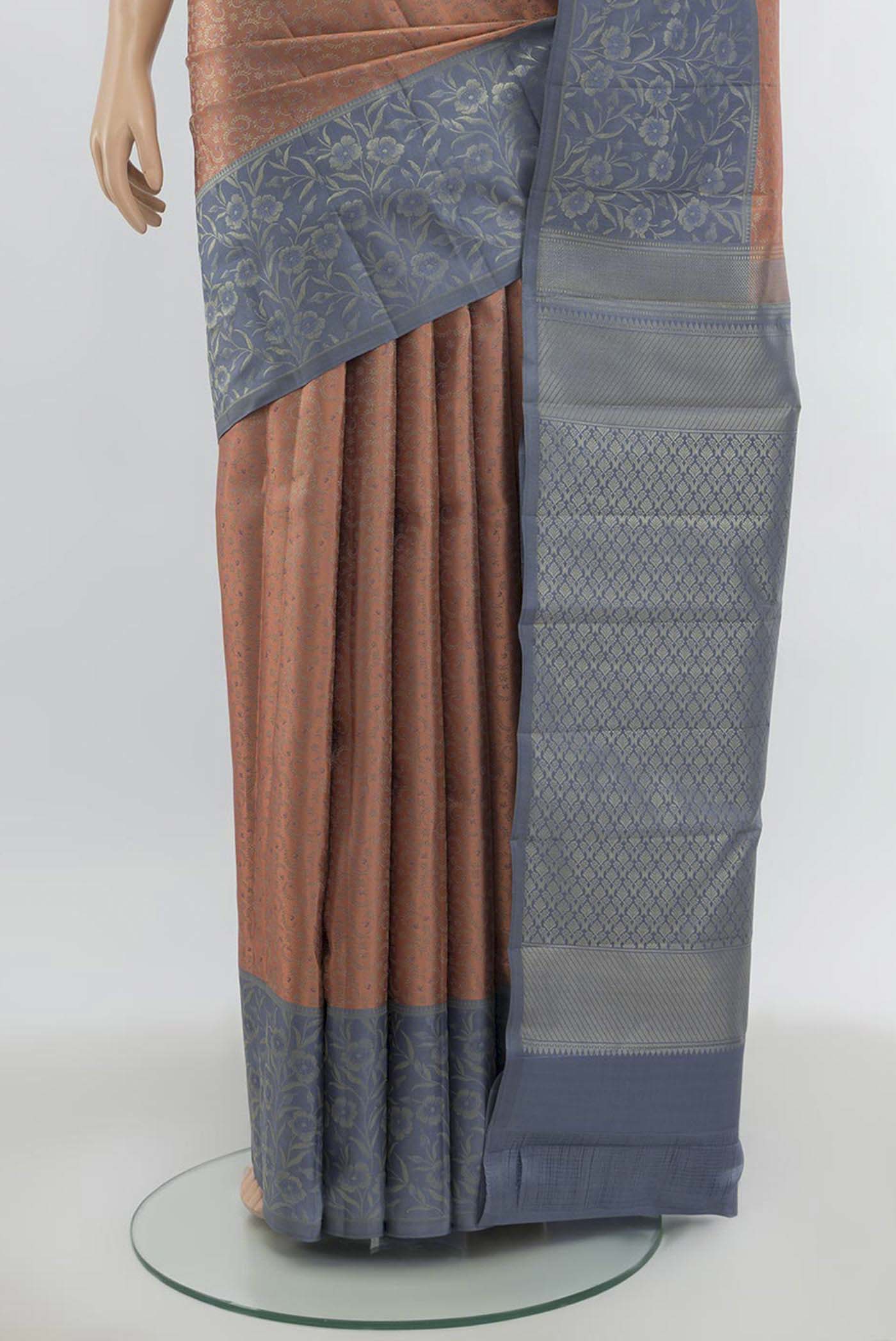 Pleats and pallu of Peach Kanchipuram Silk Saree with Zari Butta on the body and Silk Border. 