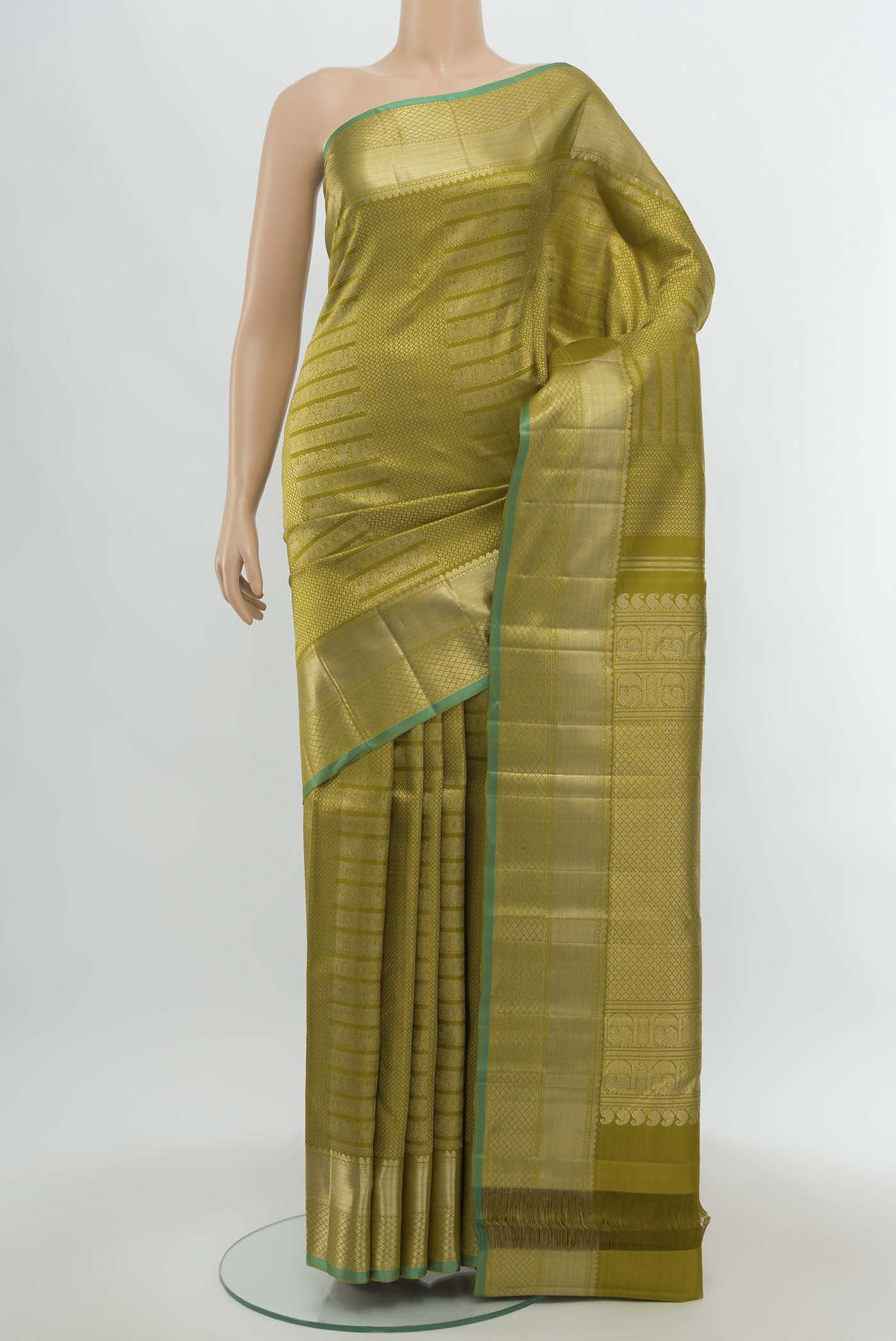 Mehandi Green Kanchipuram Silk Saree with Zari Butta on the body and Silk Border.  displayed on a mannequin