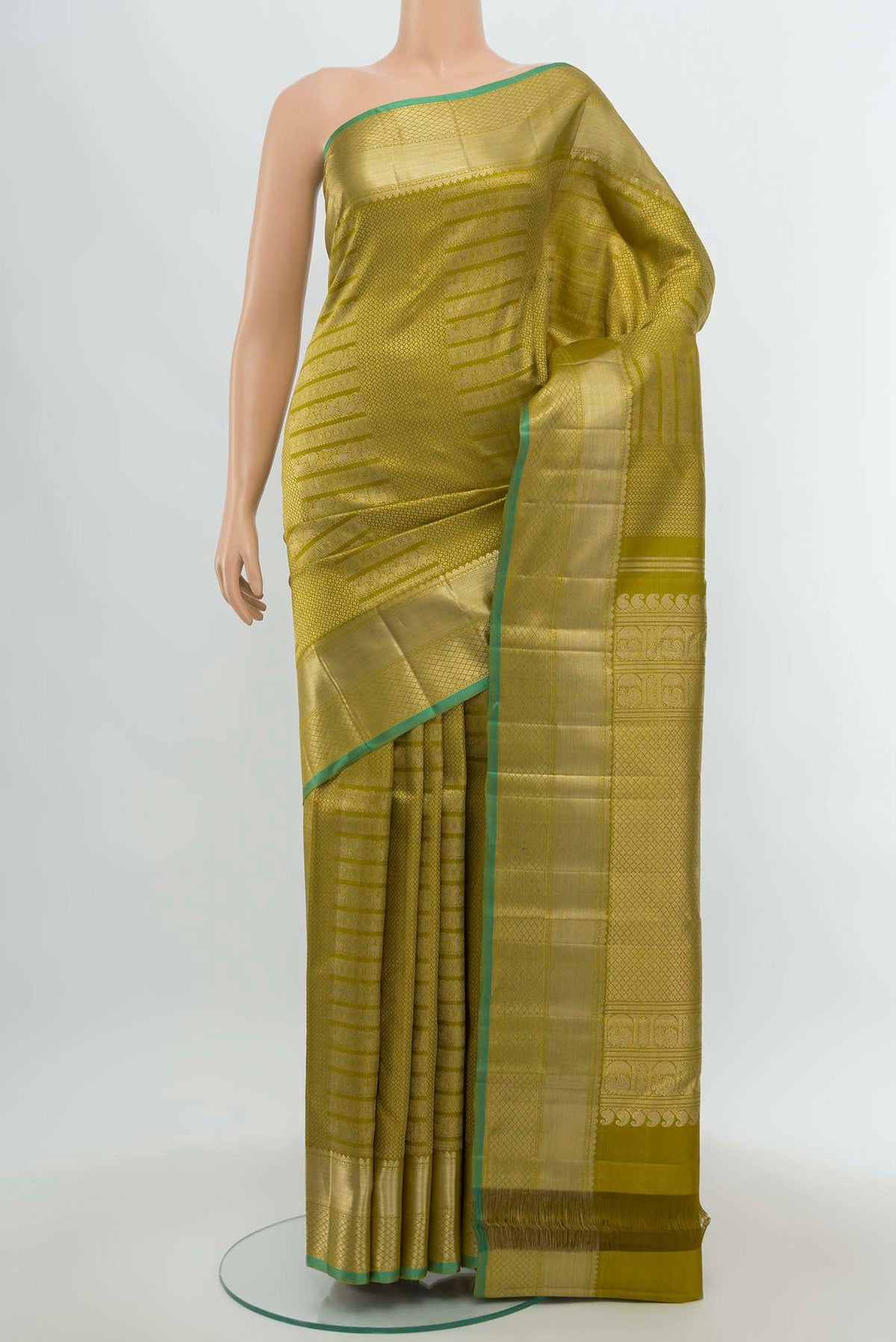 Mehandi Green Kanchipuram Silk Saree with Zari Butta on the body and Silk Border.  displayed on a mannequin