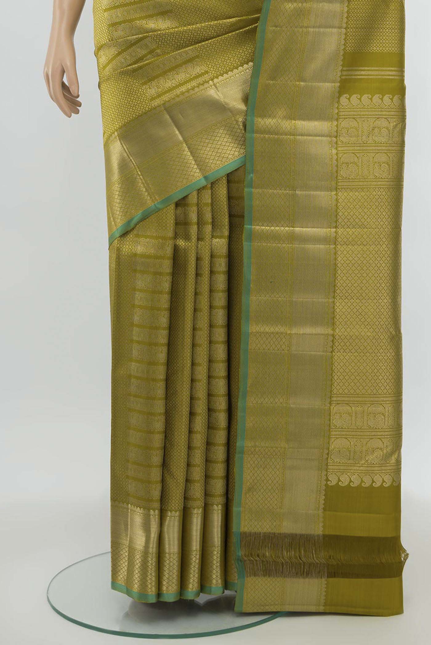 Pleats and pallu of Mehandi Green Kanchipuram Silk Saree with Zari Butta on the body and Silk Border. 