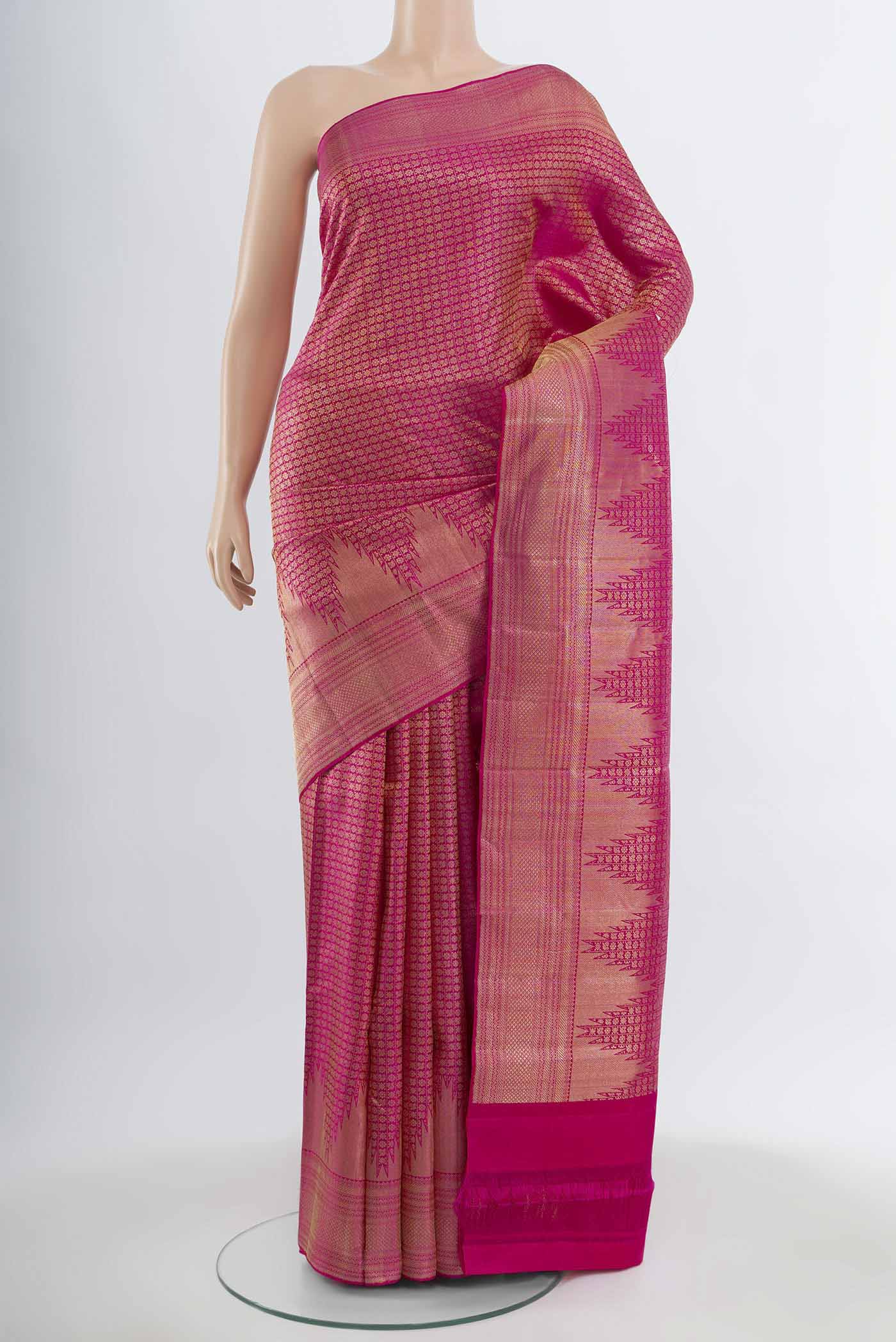 Magenta Kanchipuram Silk Saree with Zari Butta on the body and Silk Border.  displayed on a mannequin