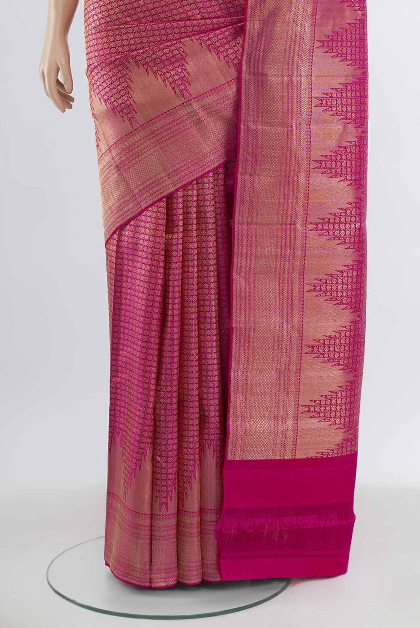 Pleats and pallu of Magenta Kanchipuram Silk Saree with Zari Butta on the body and Silk Border. 