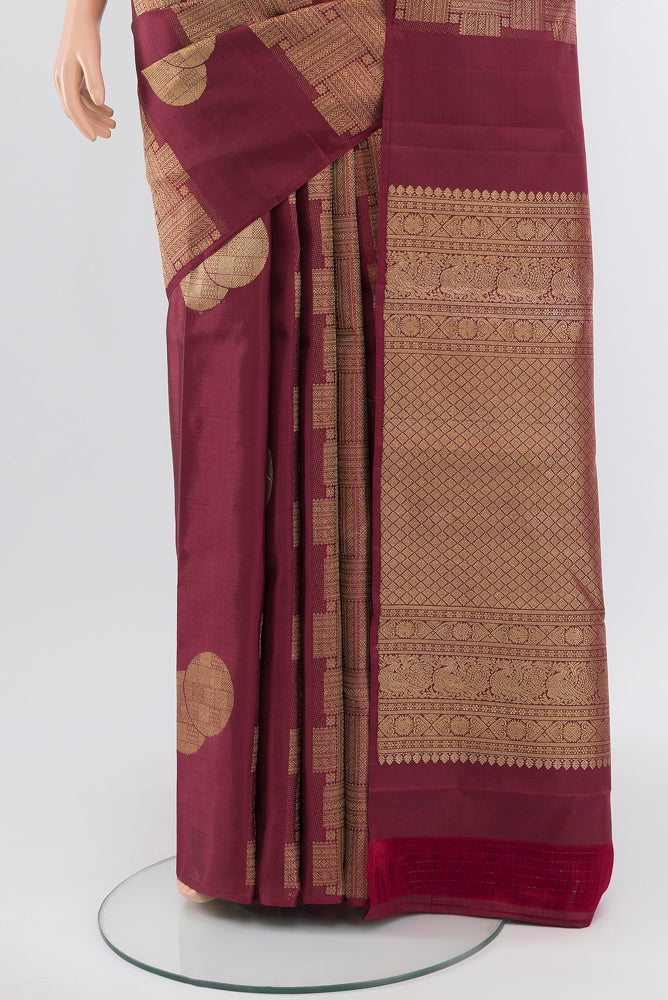 Pleats and pallu of Pure Silk Pure Zari Maroon Kanchipuram Saree with Zari Butta on the body and Silk Border. 