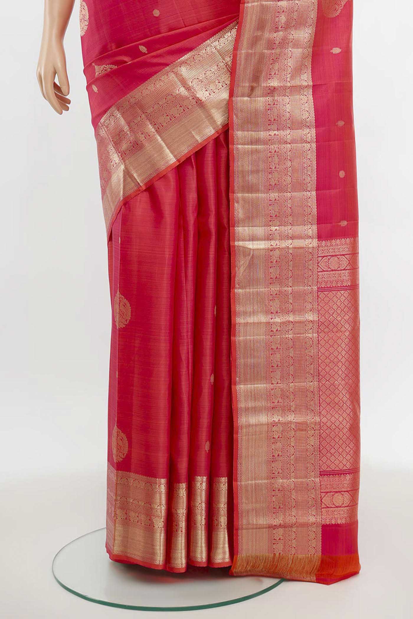 Pleats and pallu of Rose pink Kanjivaram Silk Saree with Zari Butta on the body and Silk Border. 
