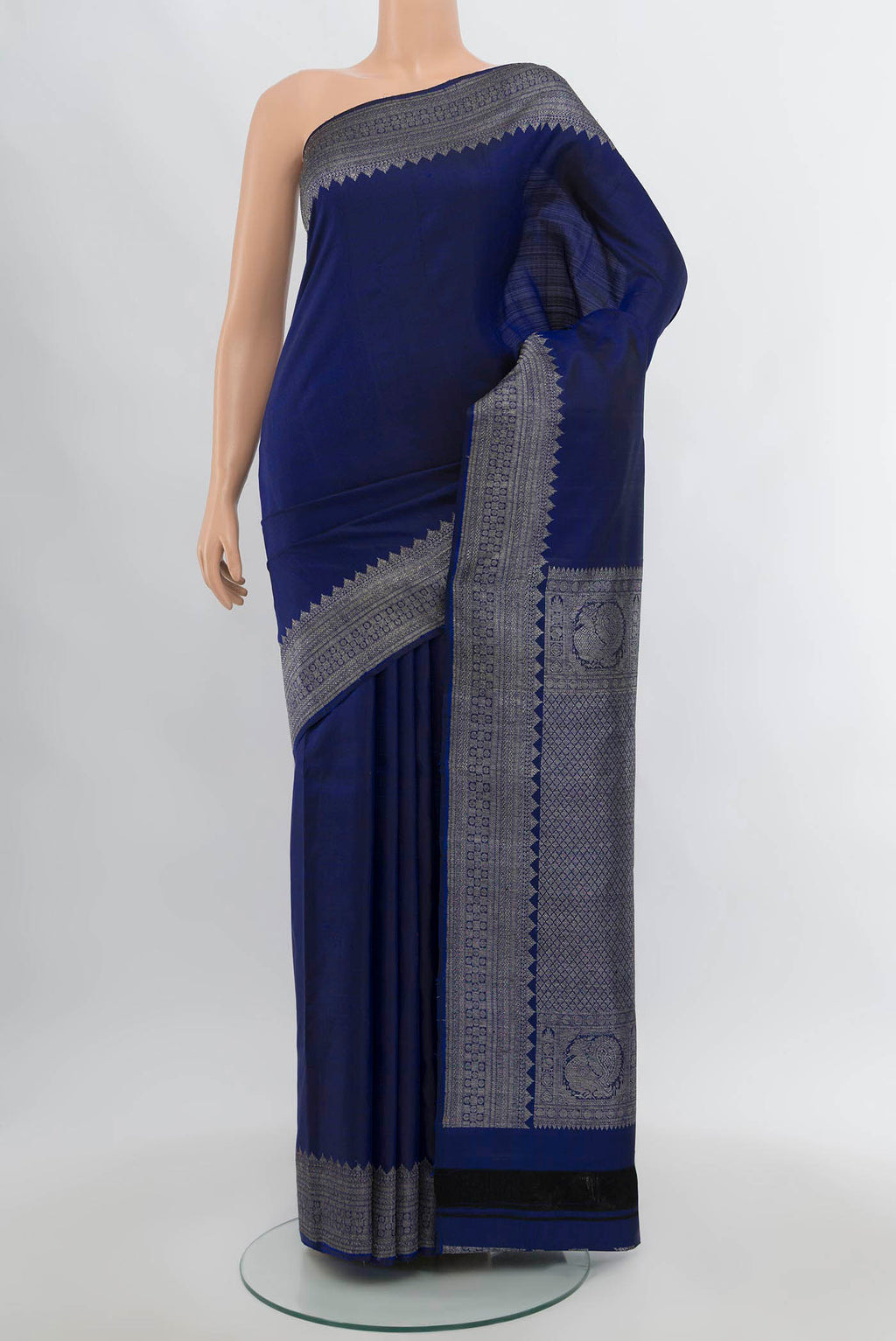 Navy Blue Kanjivaram Silk Saree with Zari Butta on the body and Silk Border.  displayed on a mannequin