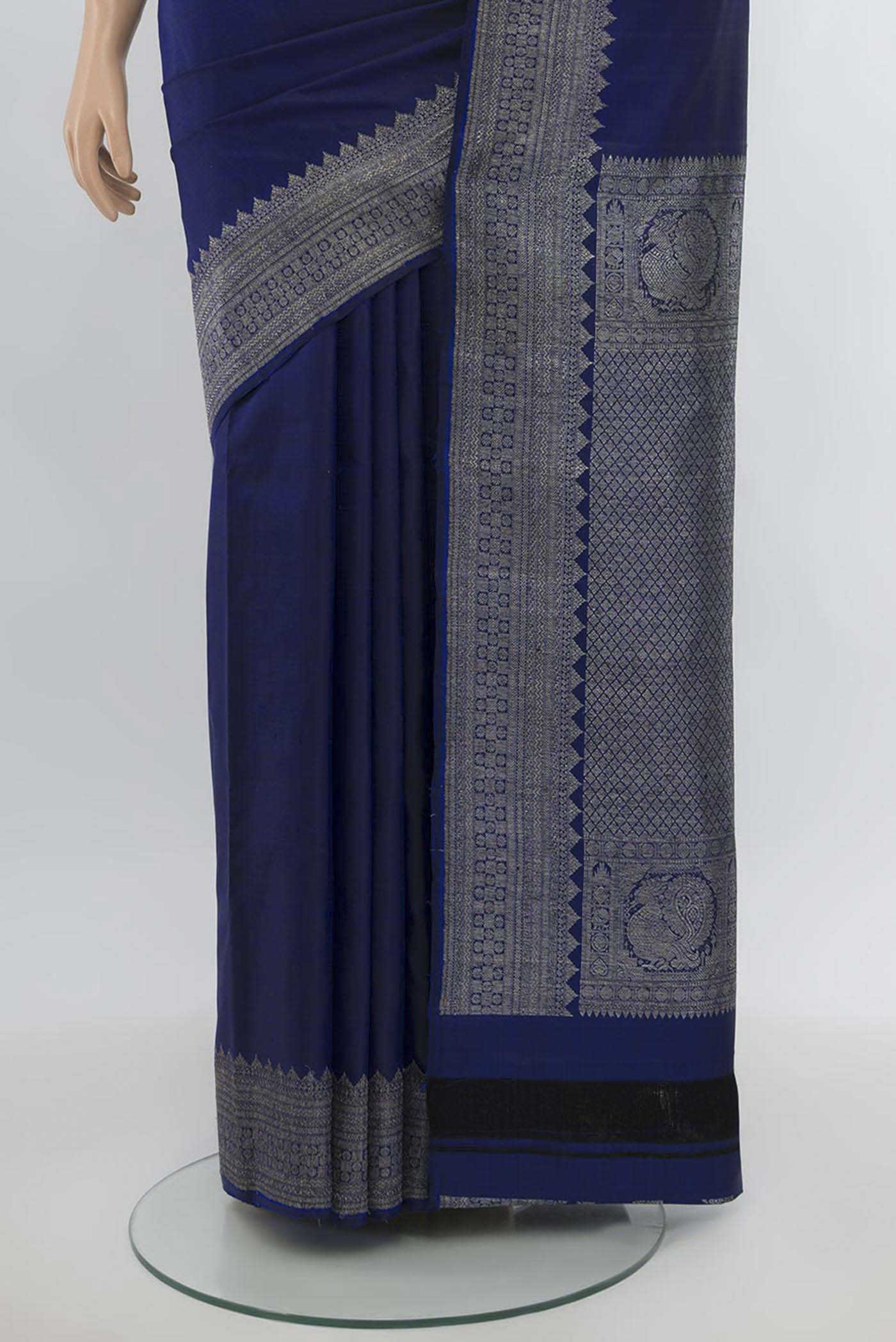 Pleats and pallu of Navy Blue Kanjivaram Silk Saree with Zari Butta on the body and Silk Border. 