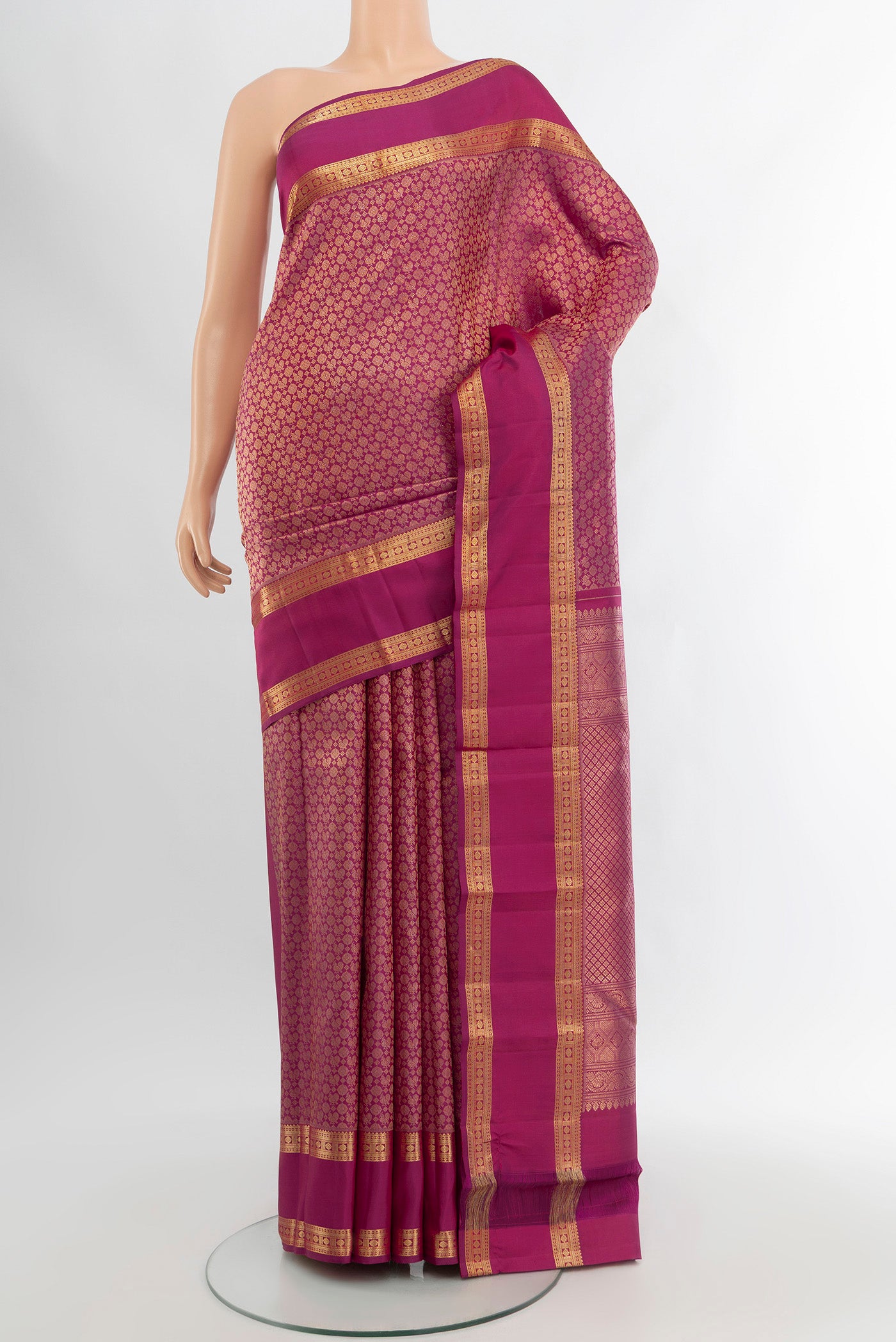 Magenta Kanchipuram Silk Saree with Zari Brocade on the body and Zari Border.  displayed on a mannequin