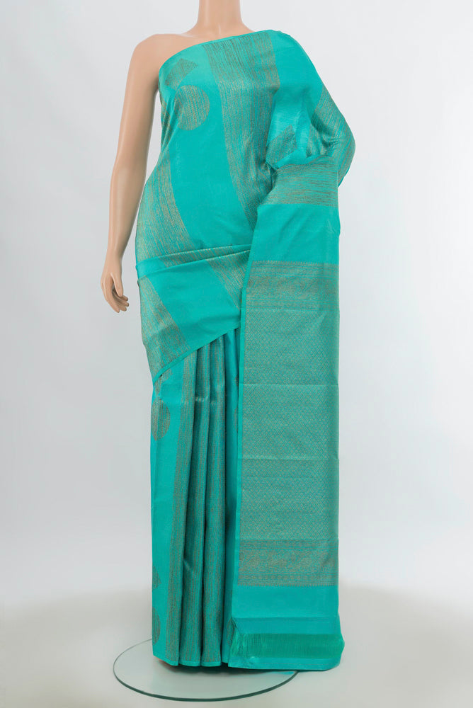 Pure Silk Pure Zari Sea Green Kanchipuram Saree with Zari Butta on the body and Silk Border.  displayed on a mannequin