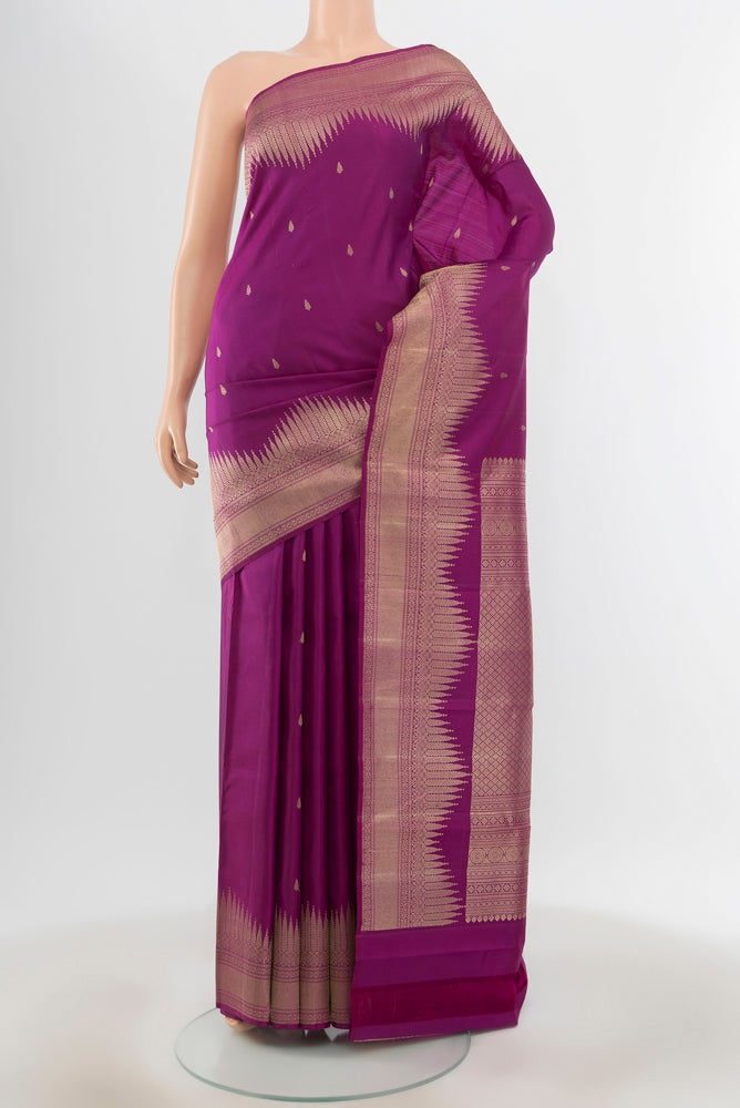 Pure Silk Pure Zari Purple Kanjivaram Saree with Zari Butta on the body and Silk Border.  displayed on a mannequin