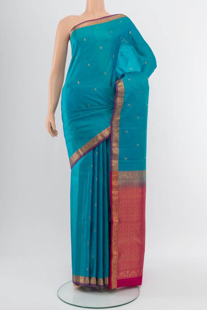 Light Blue Kanchipuram Silk Saree with Zari Butta on the body and Silk Border.  displayed on a mannequin