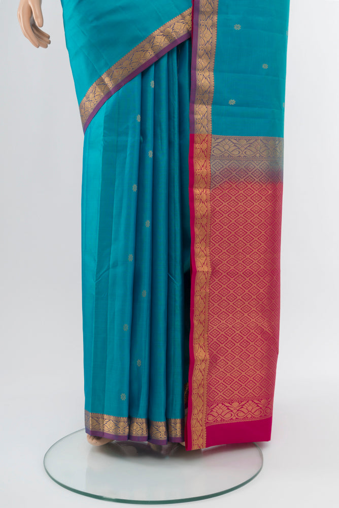 Pleats and pallu of Light Blue Kanchipuram Silk Saree with Zari Butta on the body and Silk Border. 