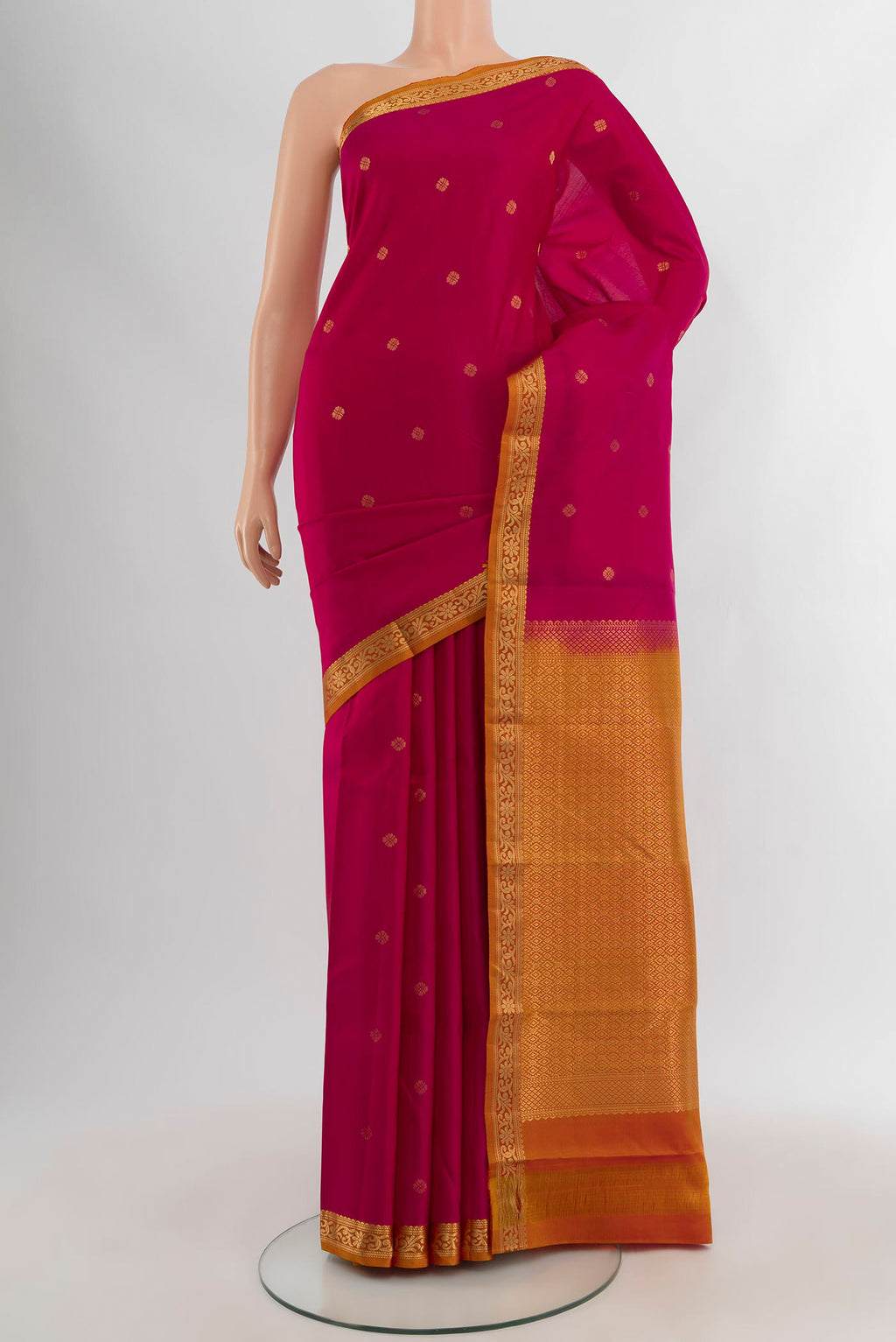 Dark Pink Kanchipuram Silk Saree with Zari Butta on the body and Zari Border.  displayed on a mannequin