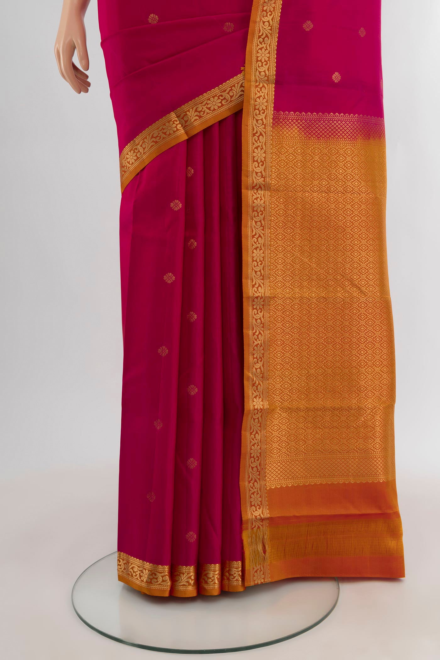 Pleats and pallu of Dark Pink Kanchipuram Silk Saree with Zari Butta on the body and Zari Border. 