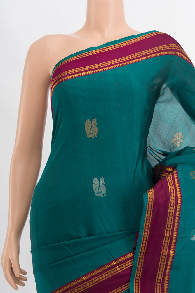 Border image of Peacock Blue Uppada Silk Saree with Zari Butta on the body and Silk Border. 