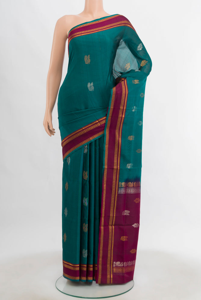 Peacock Blue Uppada Silk Saree with Zari Butta on the body and Silk Border.  displayed on a mannequin