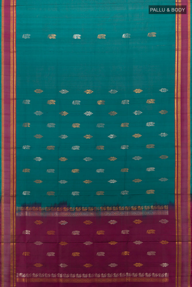 Flat view of Peacock Blue Uppada Silk Saree with Zari Butta on the body and Silk Border. 