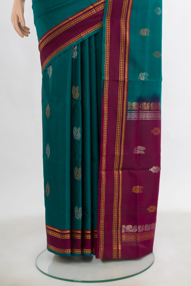 Pleats and pallu of Peacock Blue Uppada Silk Saree with Zari Butta on the body and Silk Border. 