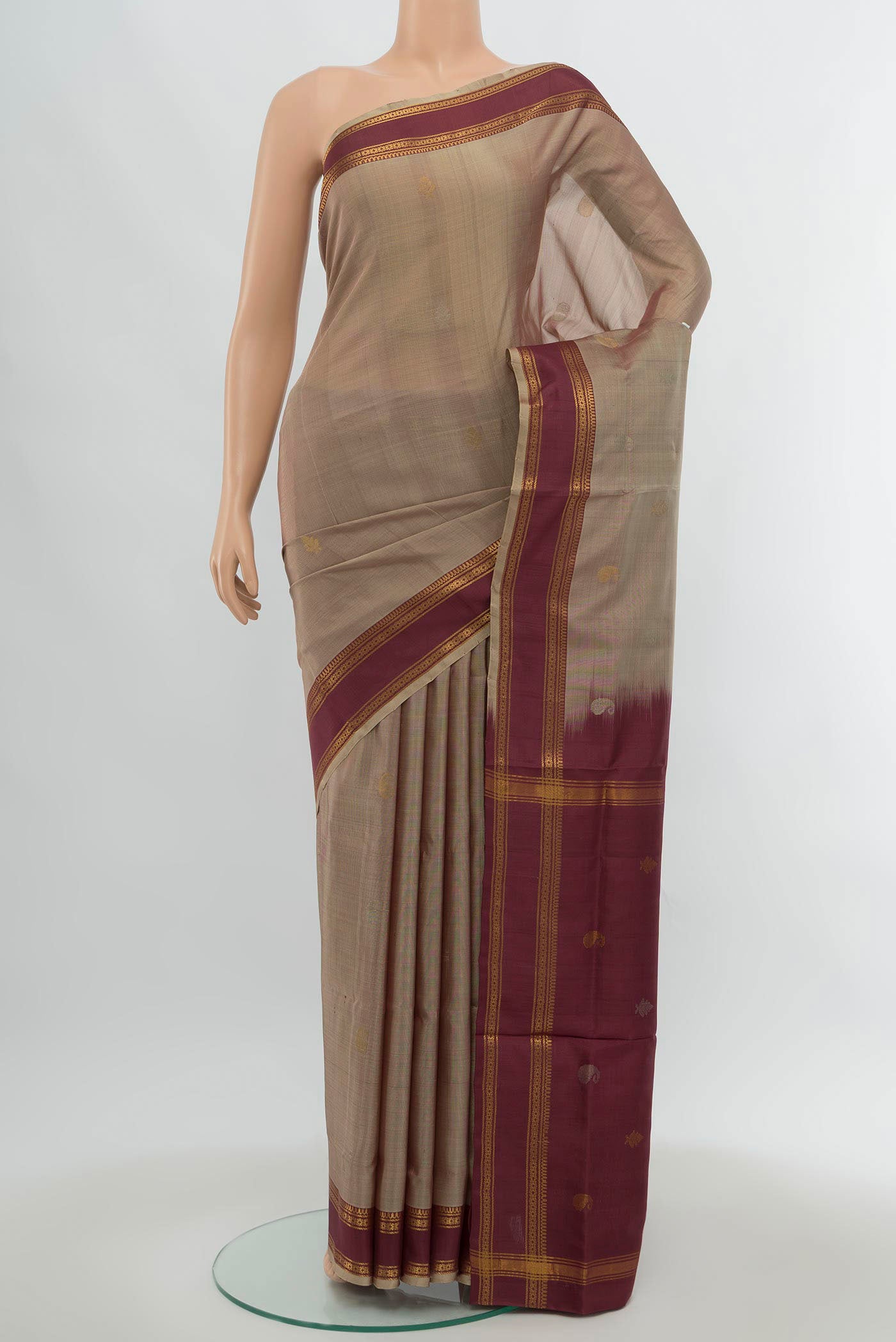 Brown Uppada Silk Saree with Zari Butta on the body and Silk Border.  displayed on a mannequin