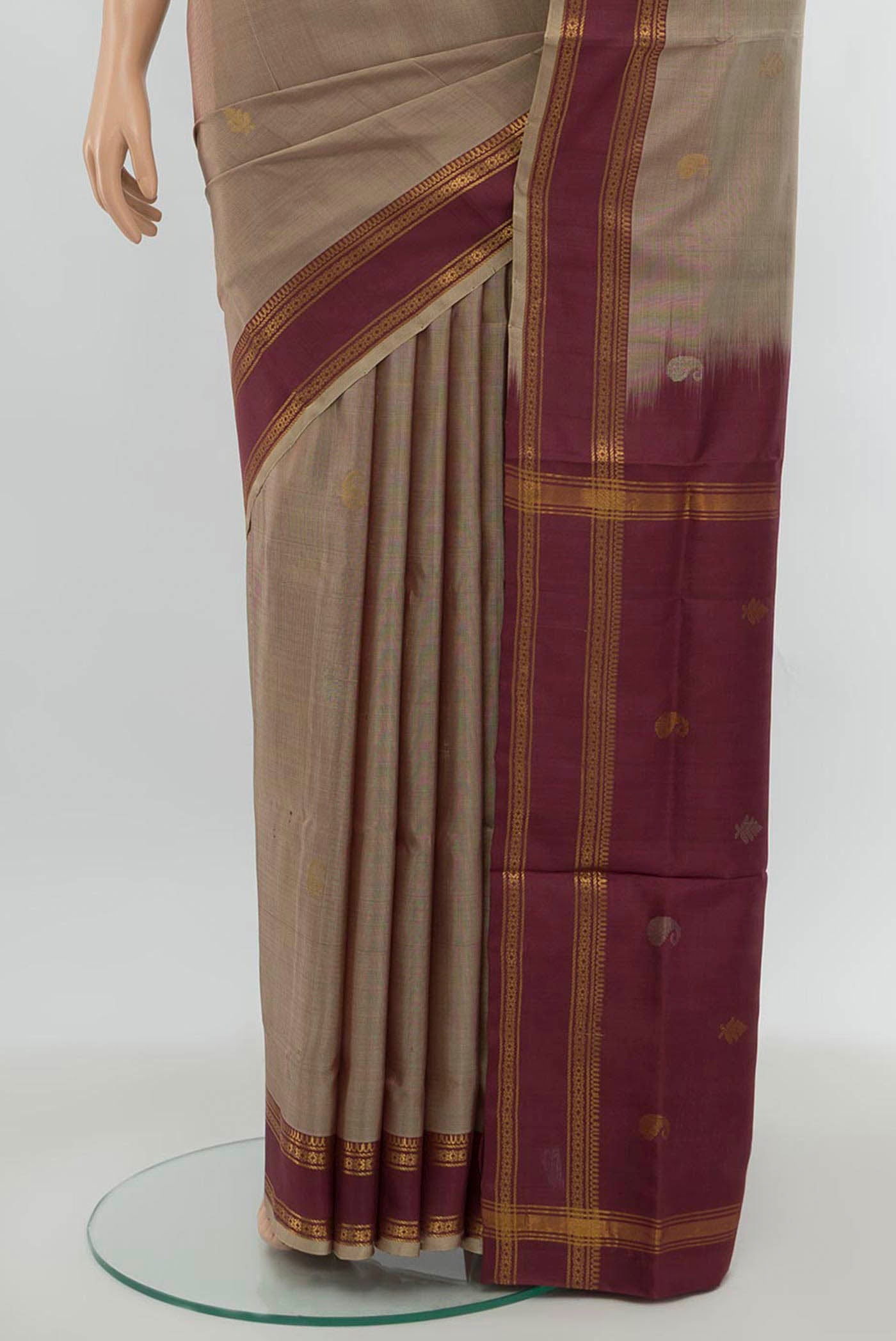 Pleats and pallu of Brown Uppada Silk Saree with Zari Butta on the body and Silk Border. 