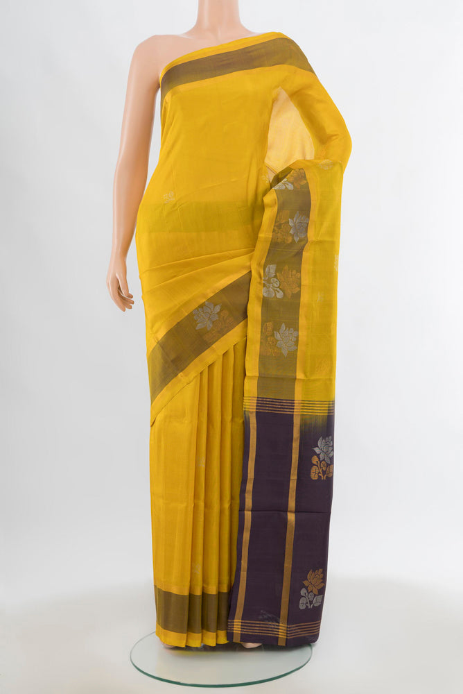 Yellow Uppada Silk Saree with Zari Butta on the body and Silk Border.  displayed on a mannequin