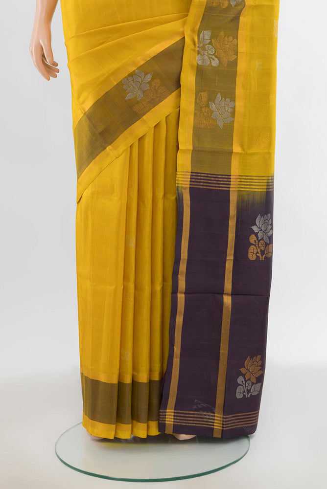 Pleats and pallu of Yellow Uppada Silk Saree with Zari Butta on the body and Silk Border. 